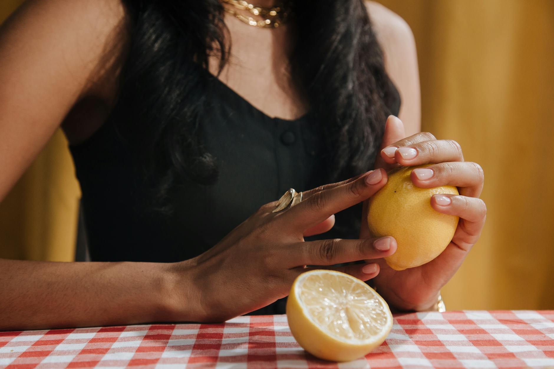 A blue silicone clitoral vibrator held in hand, representing a tool for reclaiming pleasure during anxiety.