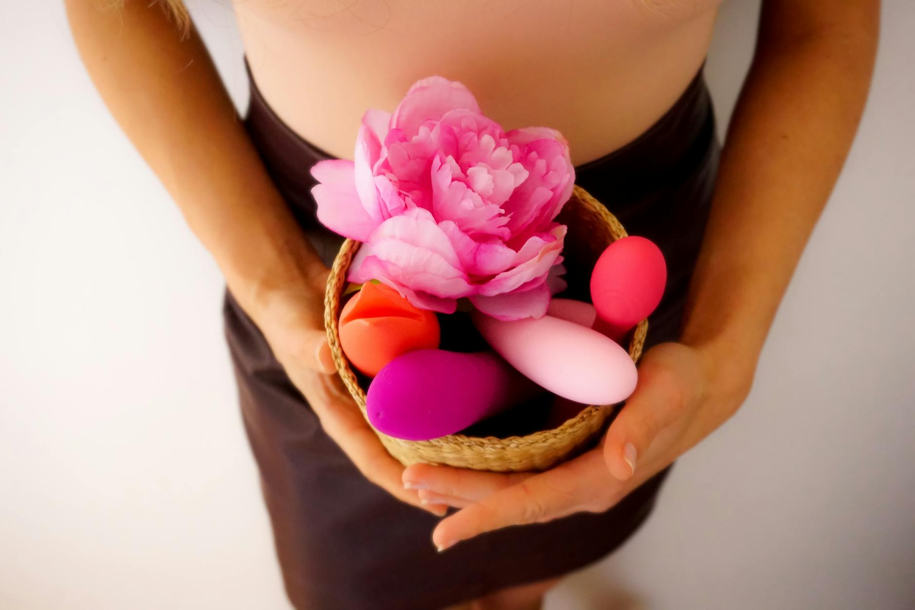 A basket of colorful vibrators including a lemon-shaped toy, representing diverse sensuality options during menopause